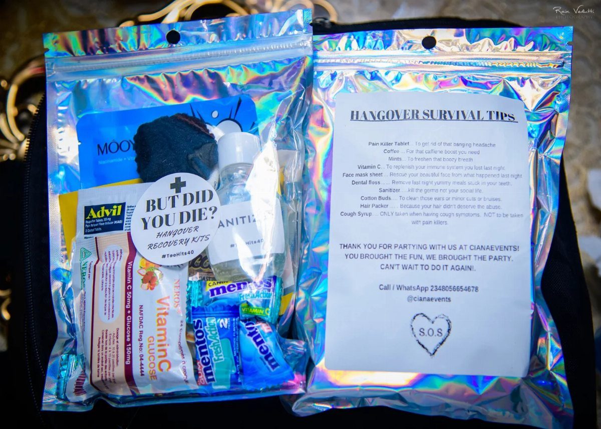 Two iridescent holographic pouches containing hangover recovery supplies and a survival tips list.