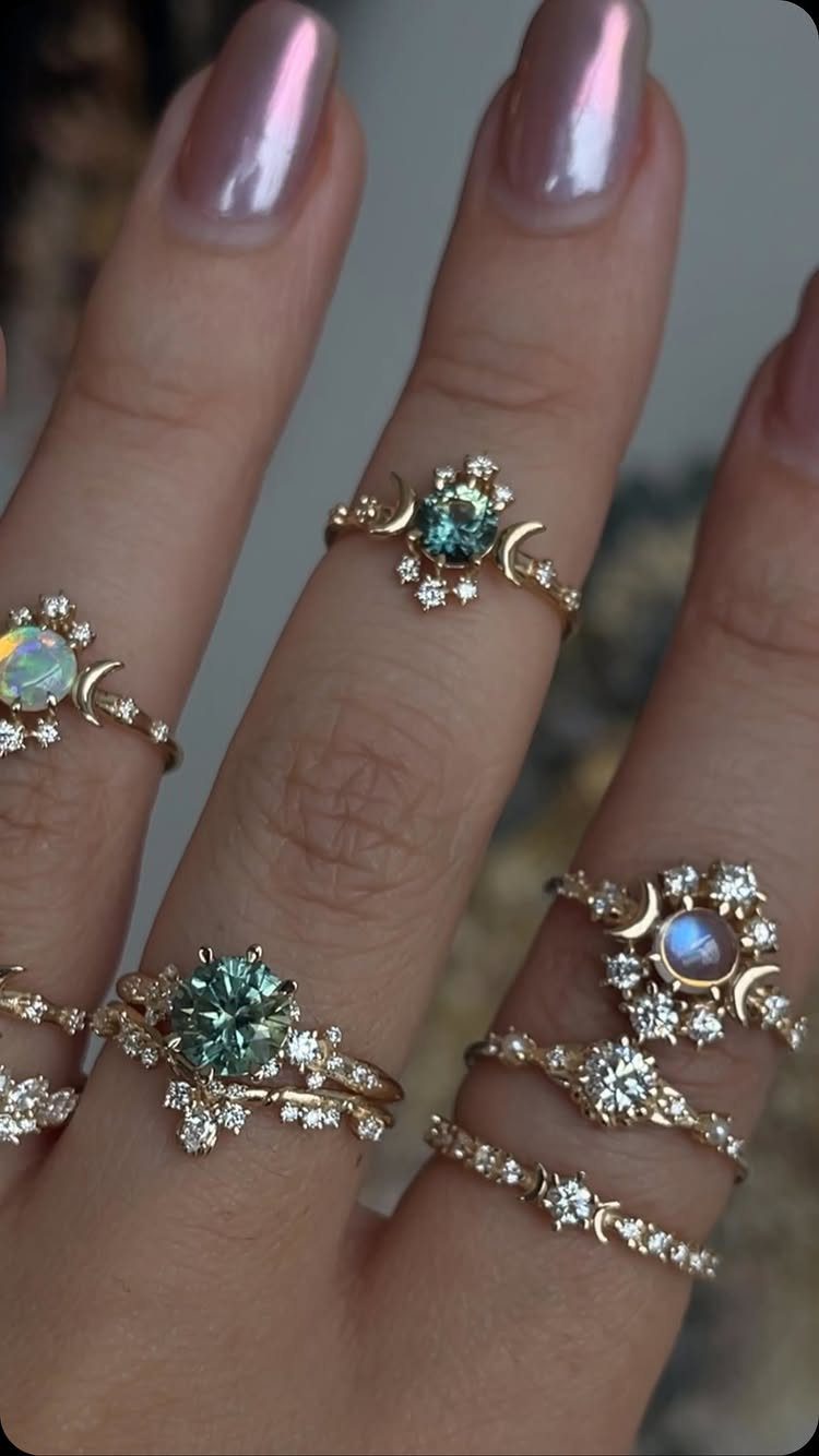 Gold boho engagement rings with celestial moon and star motifs on a hand
