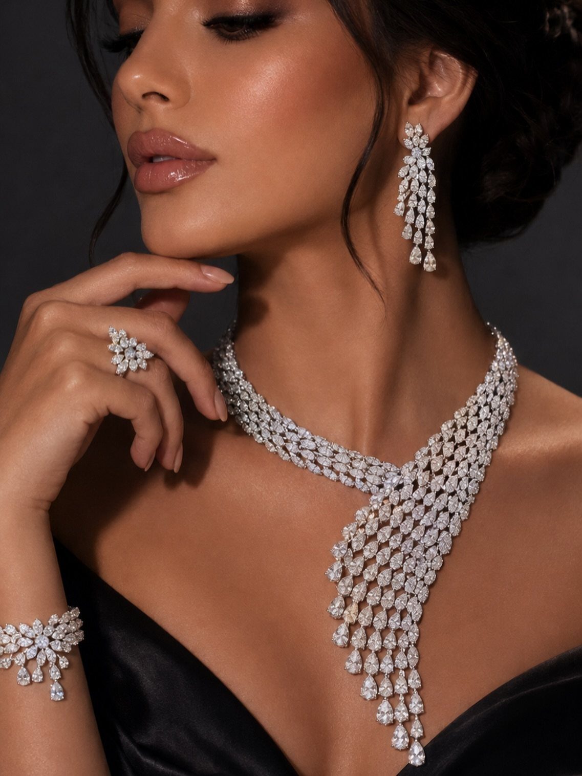Woman wearing a cascading geometric diamond statement necklace and matching bridal jewellery set.