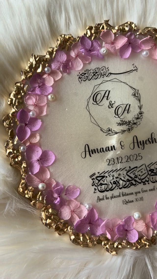 Decorative circular plaque with gold rim, purple flowers, and personalized wedding calligraphy.