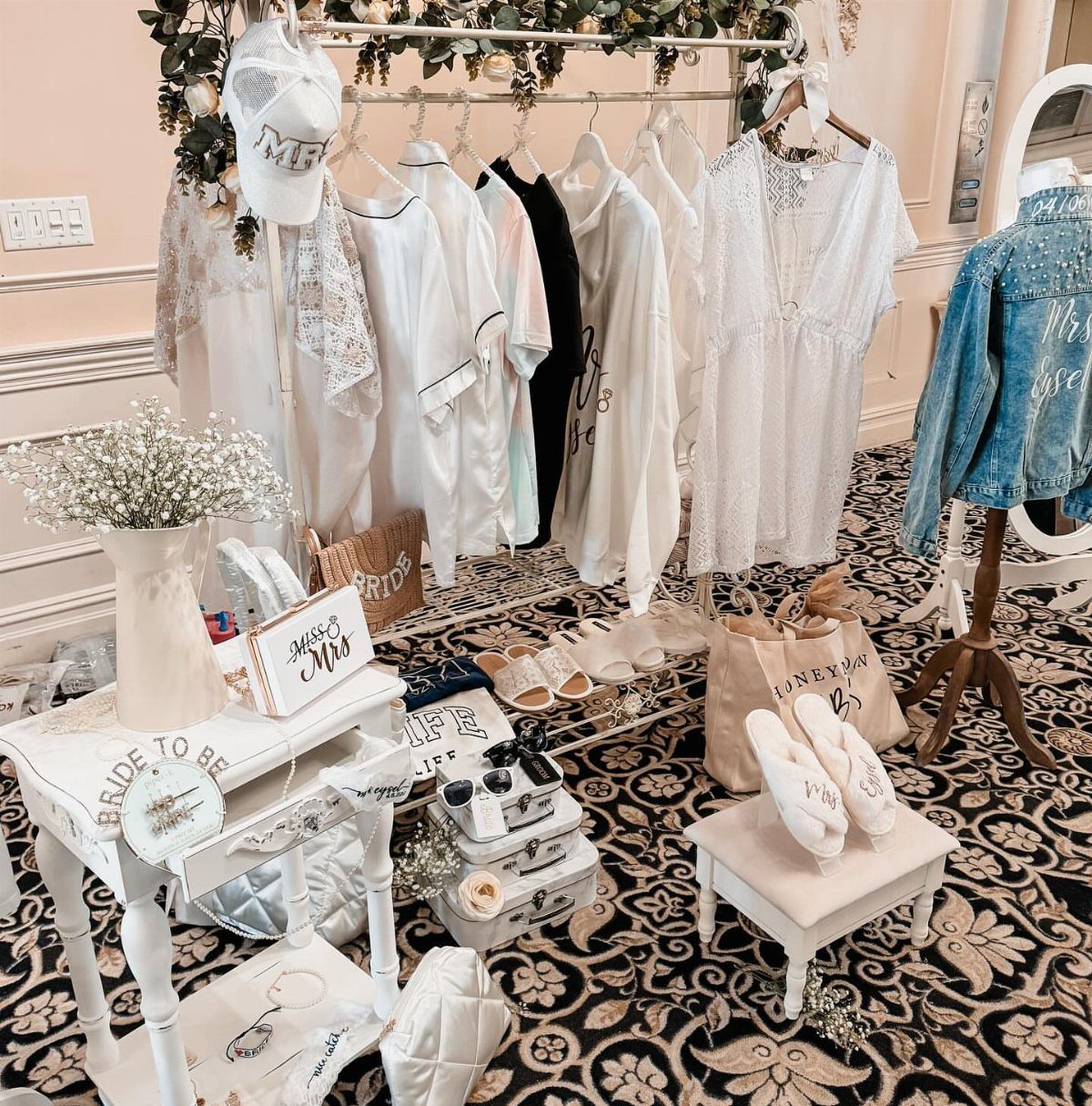Bridal robes, slippers, and accessories arranged for a wedding day preparation scene.