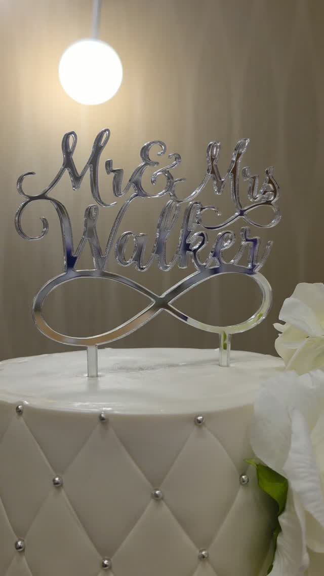 White quilted cake with silver beads and a mirrored Mr and Mrs topper