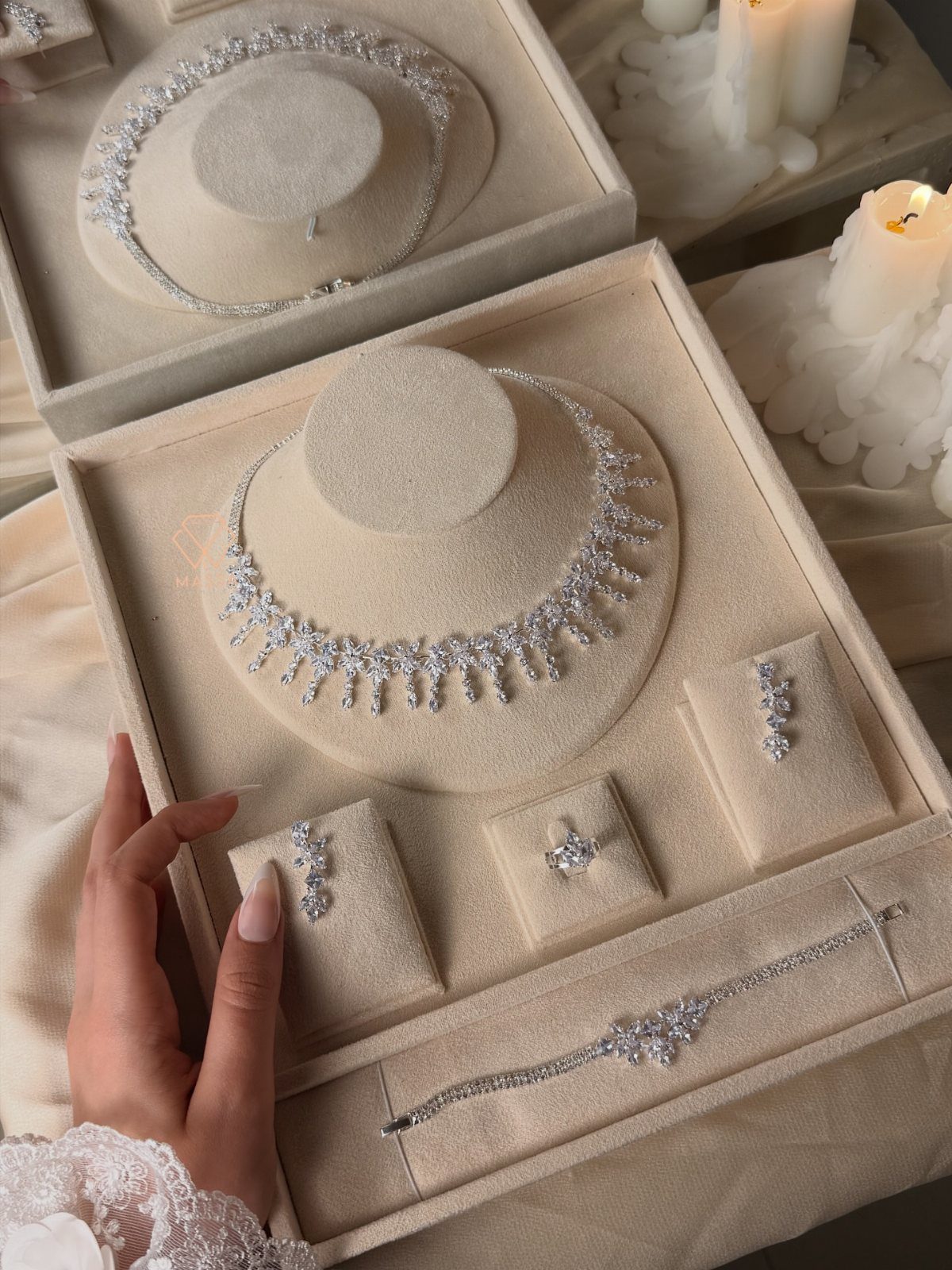 Diamond bridal jewelry set with necklace, earrings, ring, and bracelet in beige box