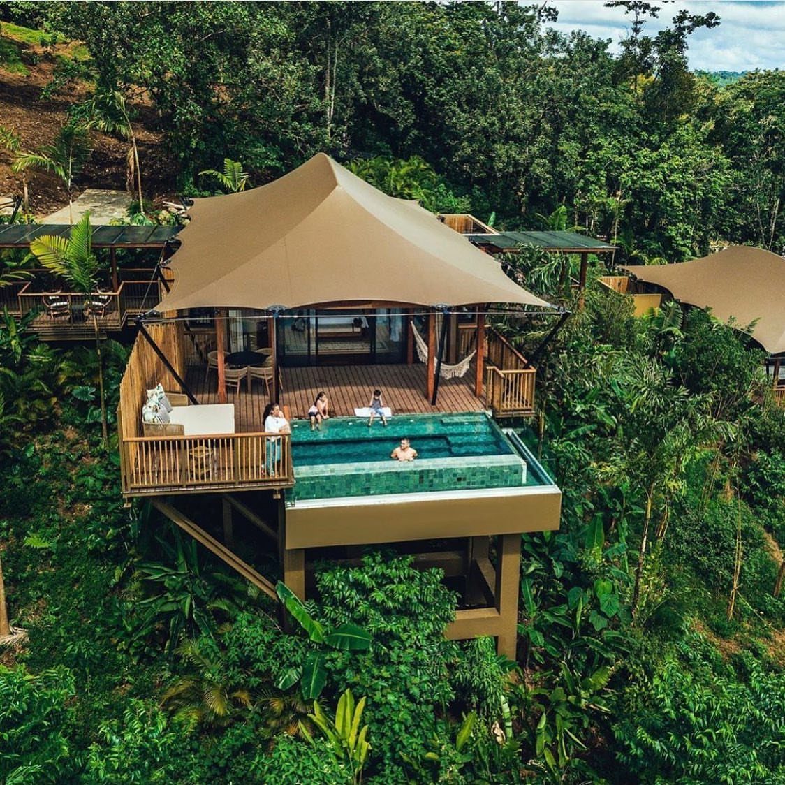 Luxury tented villa with a private pool nestled in a lush tropical rainforest.