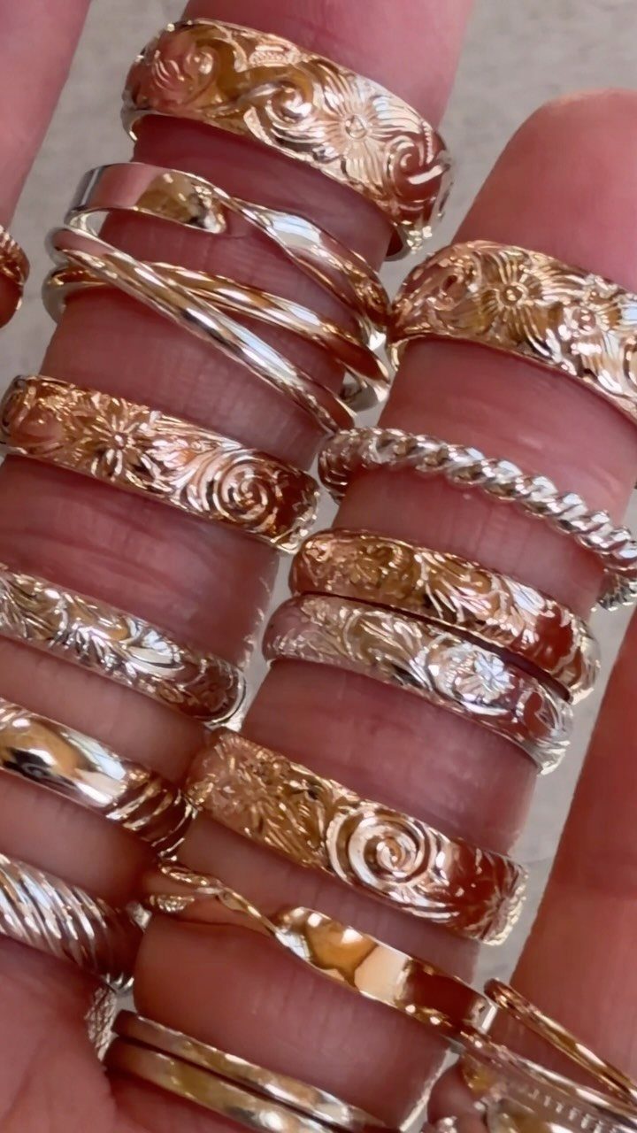Mixed metal gold rings in white, yellow, and rose gold on fingers
