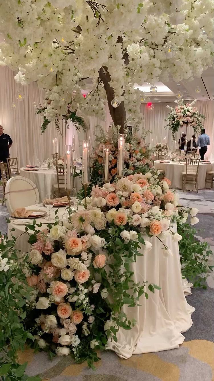 Peach and white rose floral runner on a white wedding sweetheart table.