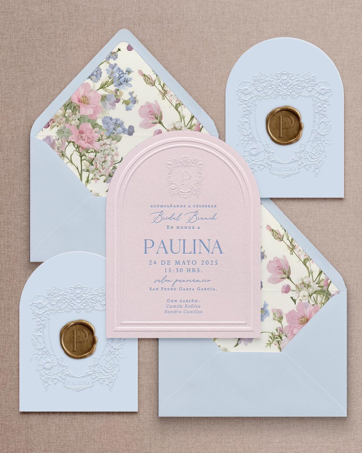 Arch-top pink and blue wedding invitations with floral linings and gold wax seals.