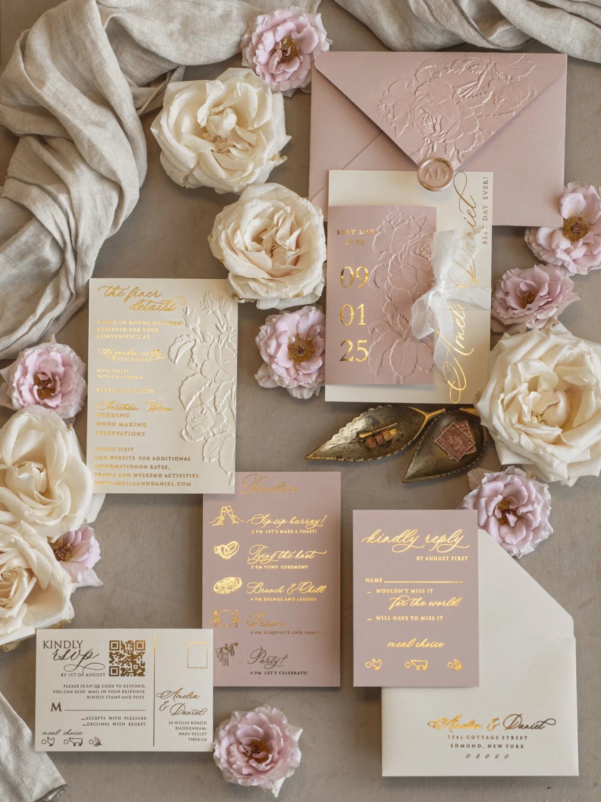 Wedding invitation suite with gold foil text and pink roses on neutral background