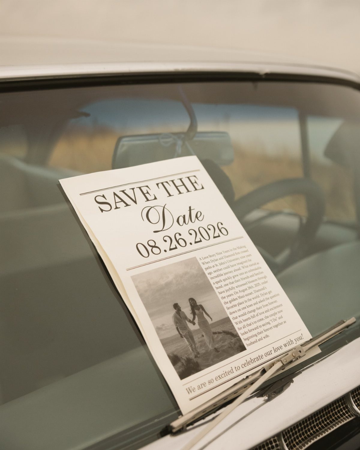 Save the date card on a vintage car windshield featuring a couple's photo.