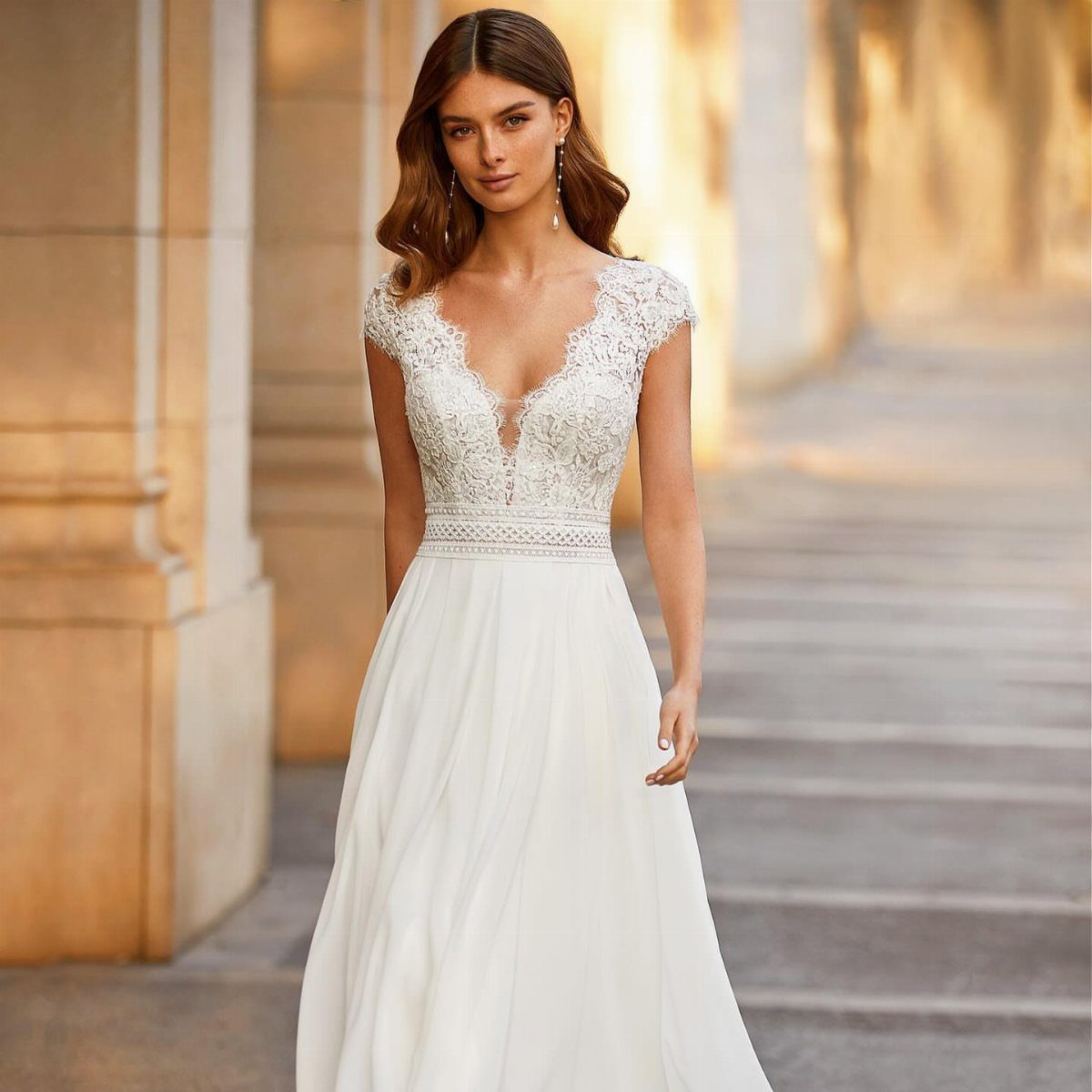 Woman in a white wedding dress with lace bodice and flowing lightweight skirt