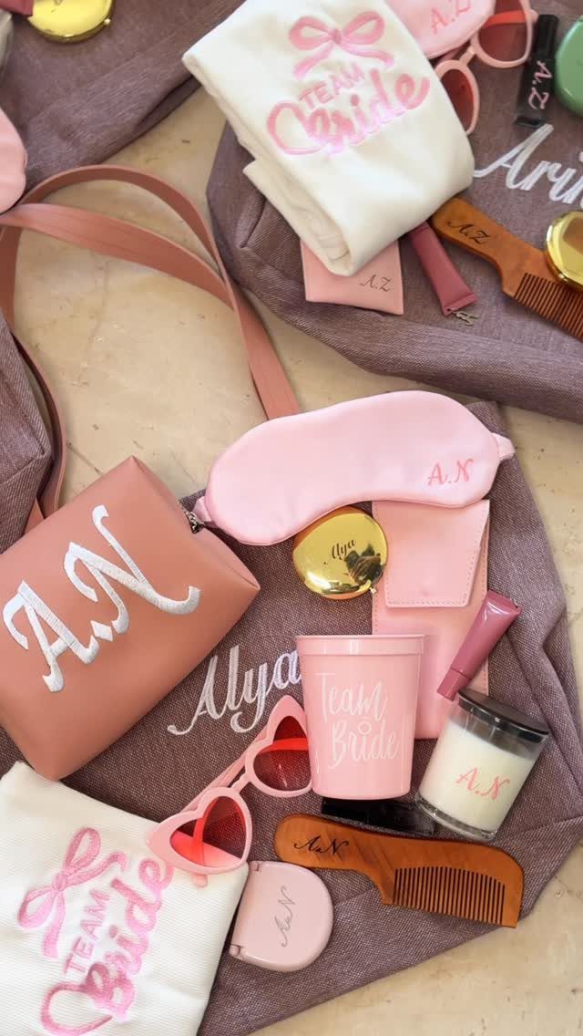 Bridal party gift set with pink accessories, including a bag, cup, and sleep mask.