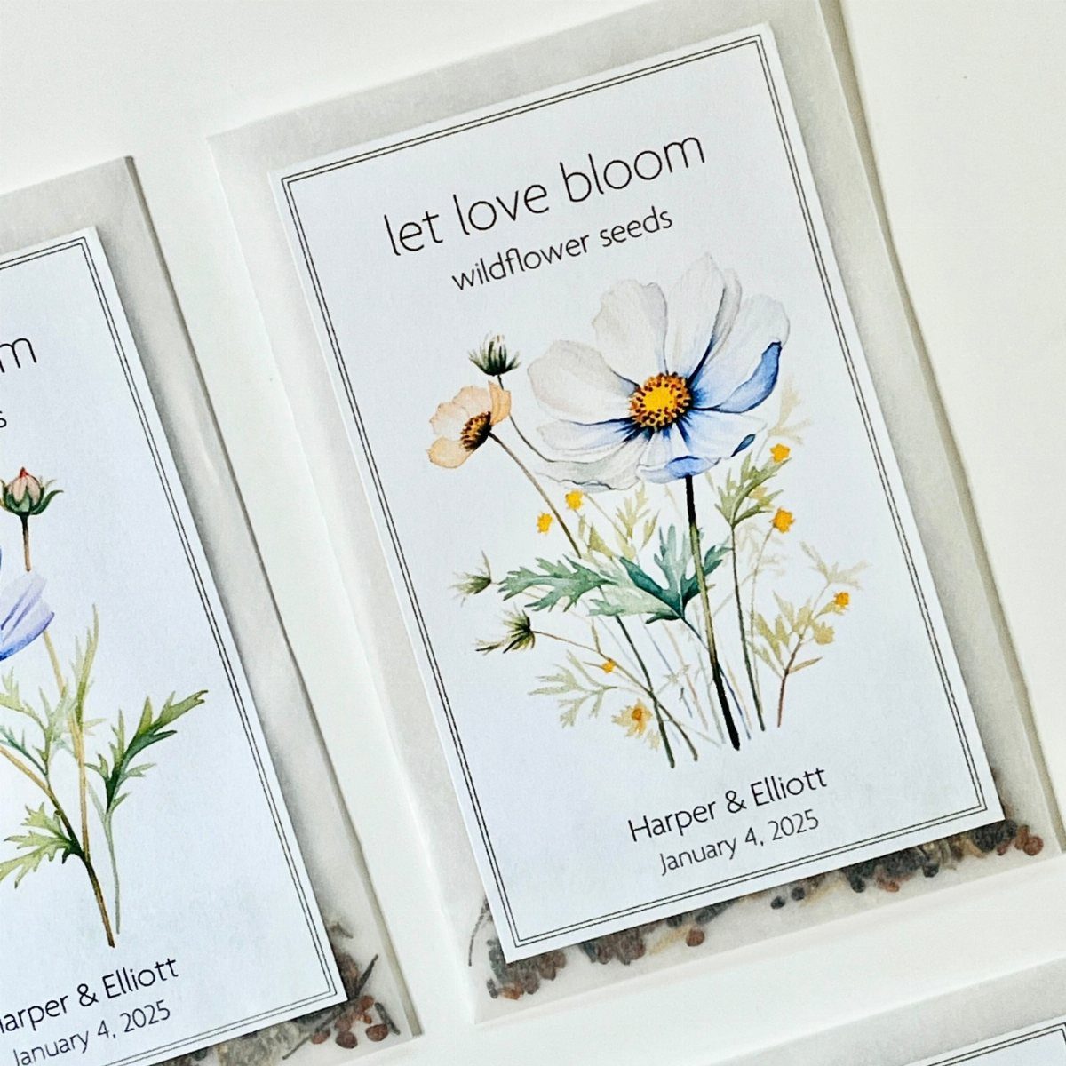 Wildflower seed packets with floral illustrations and personalized wedding names and date.