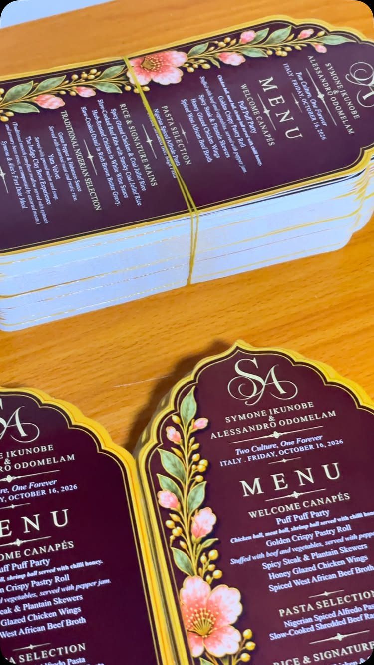 Wedding menu cards with maroon backgrounds and floral designs listing various food courses.