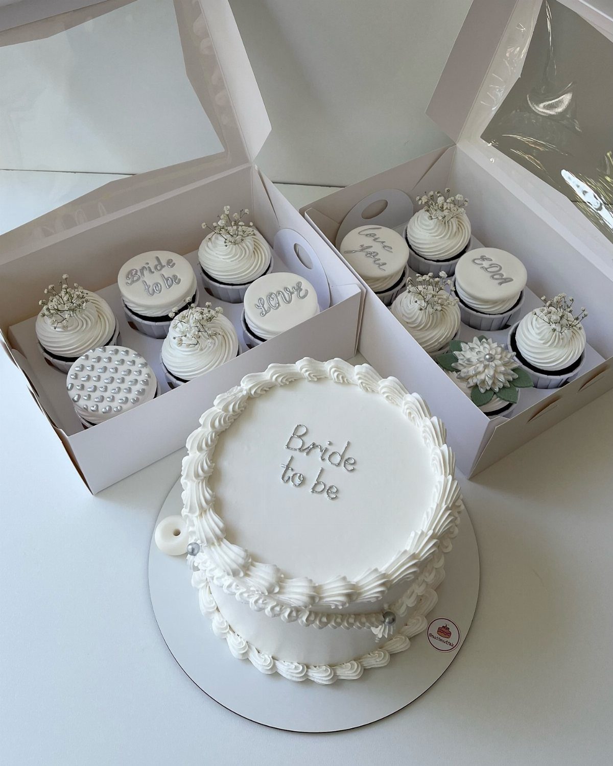 White bride to be cake and matching cupcakes in white bakery boxes