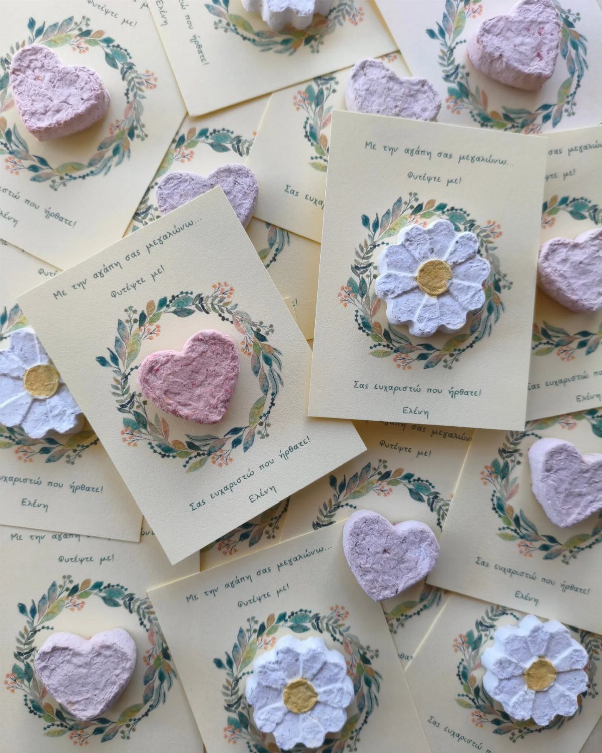 Seed paper hearts and flowers on cream cards with floral wreath designs.